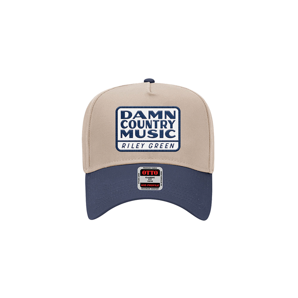 A two-toned snapback hat with 'Damn Country Music' text and a logo on the front.