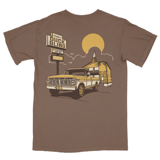 Brown t-shirt with a graphic of a truck and duck blind sign on a white background Riley Green diamond logo on license plate