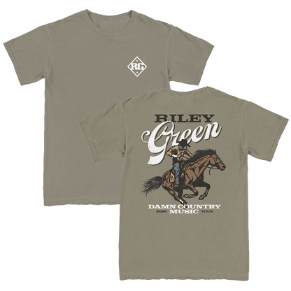 A green t-shirt with a graphic print of a cowboy riding a horse and the text 'BILLY GREEN DAMN COUNTRY MUSIC'.