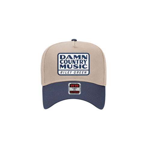 A two-toned snapback hat with 'Damn Country Music' text and a logo on the front.
