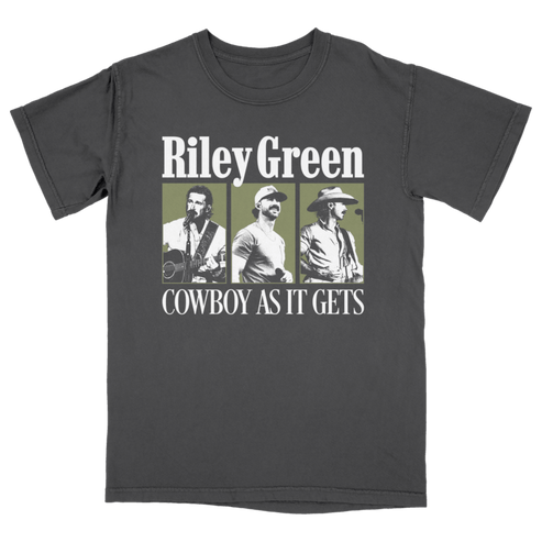 A dark gray crewneck t-shirt featuring a graphic print of three photos of country music artist Riley Green with the text 'Riley Green' and 'COWBOY AS IT GETS' in white, set against a solid green background.