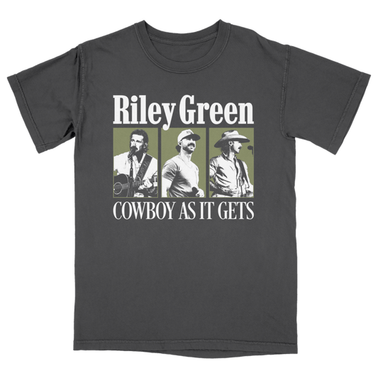 A dark gray crewneck t-shirt featuring a graphic print of three photos of country music artist Riley Green with the text 'Riley Green' and 'COWBOY AS IT GETS' in white, set against a solid green background.