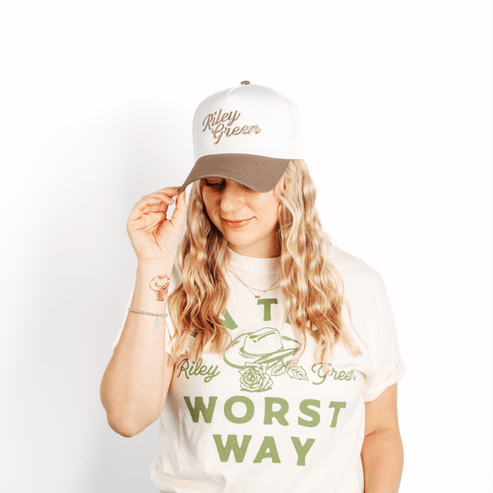 Person wearing a cap and t-shirt with text and graphics on a white background